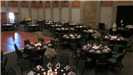 Elegant black and white wedding reception of pre set tables with black table cloths accented with wh