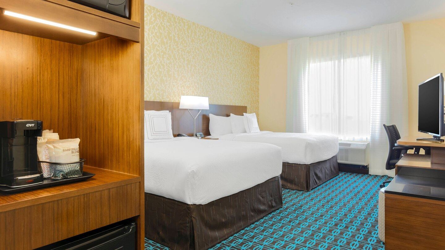 Queen guest room with two beds and complimentary accommodations