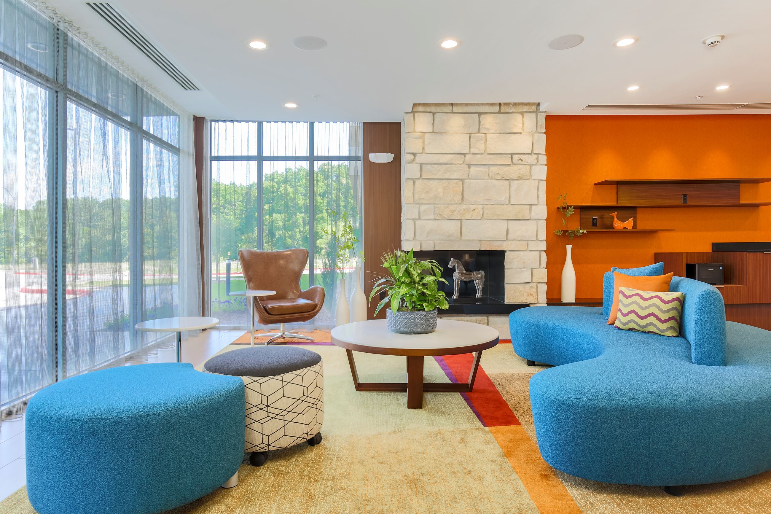 Hotel Lobby with modern retro furniture on multi colored rugs
